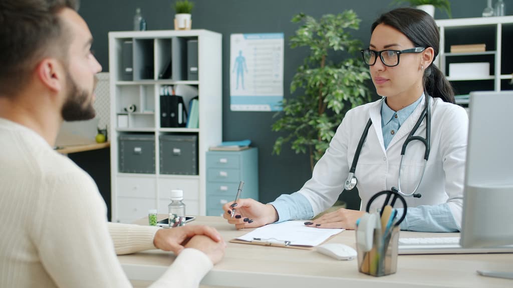 Man meeting with his doctor to discuss appointing a healthcare representative and HIPAA access in Indiana