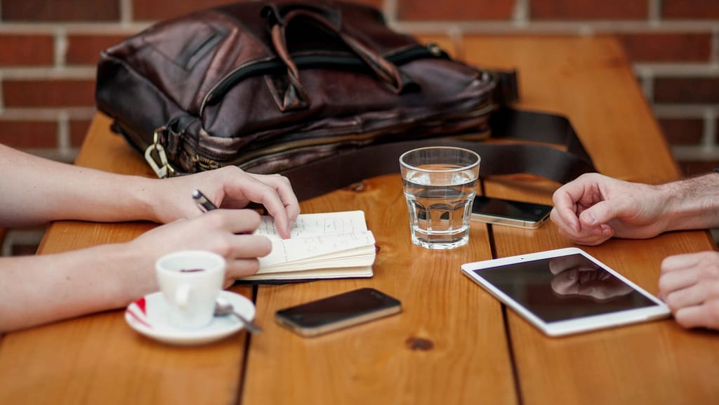 Two people reviewing essential estate planning documents at a table