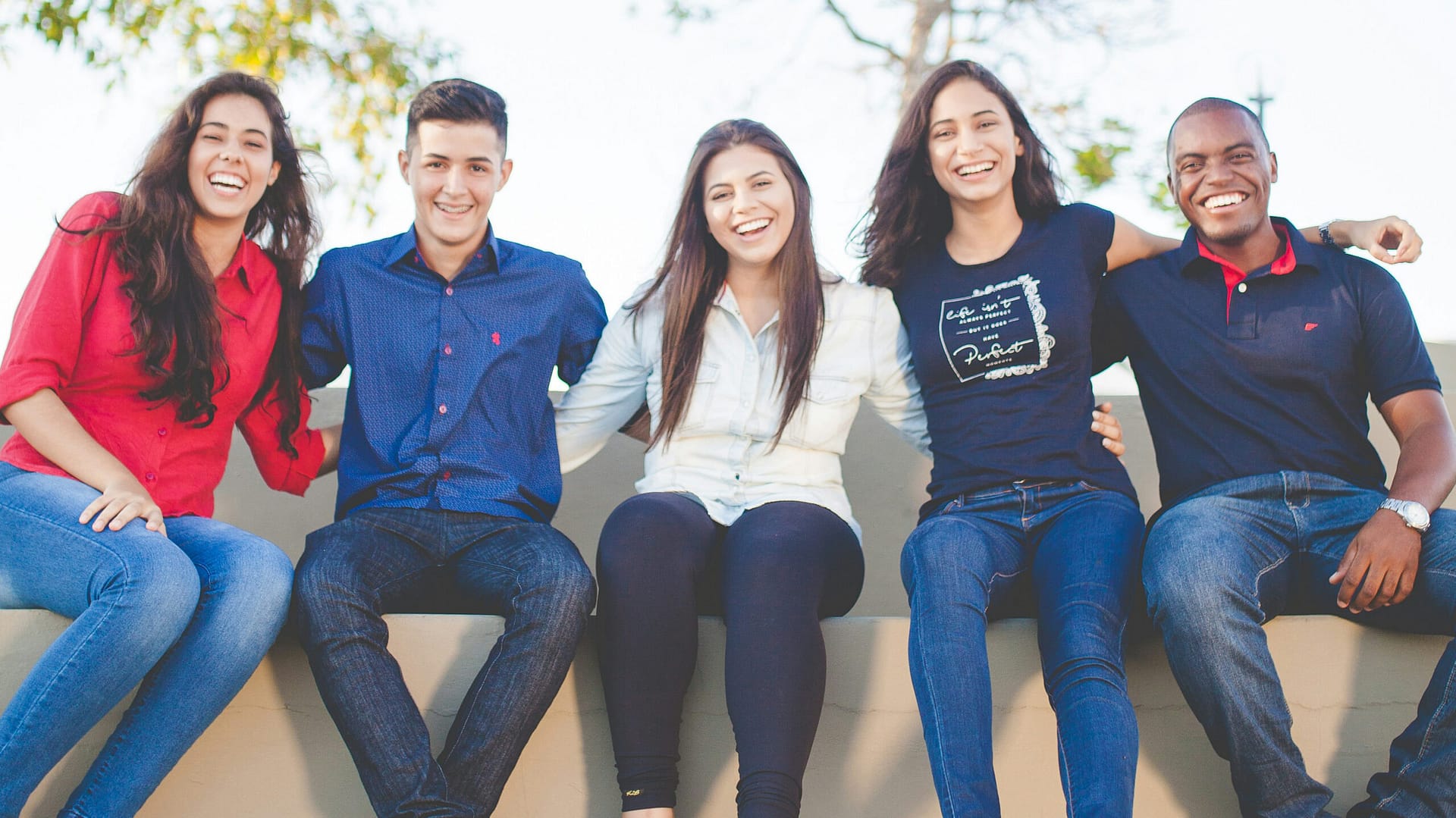 Group of young adult friends laughing together outdoors, planning ahead with estate documents in Indiana