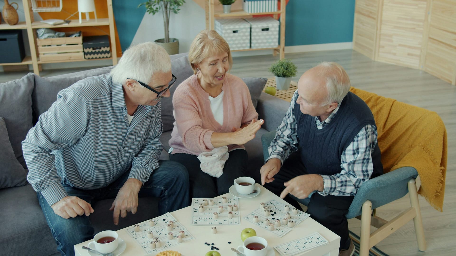 Three elderly adults having a conversation at home in Indiana