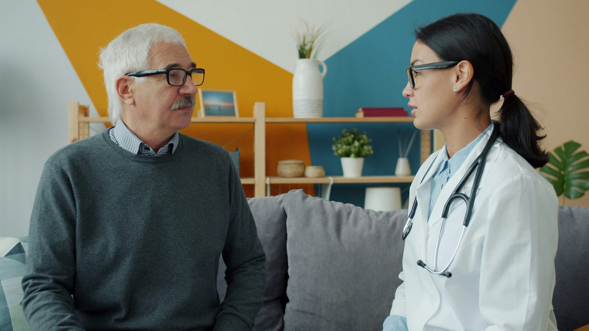 A doctor consults with an elderly patient at home about Medicaid planning in Indiana