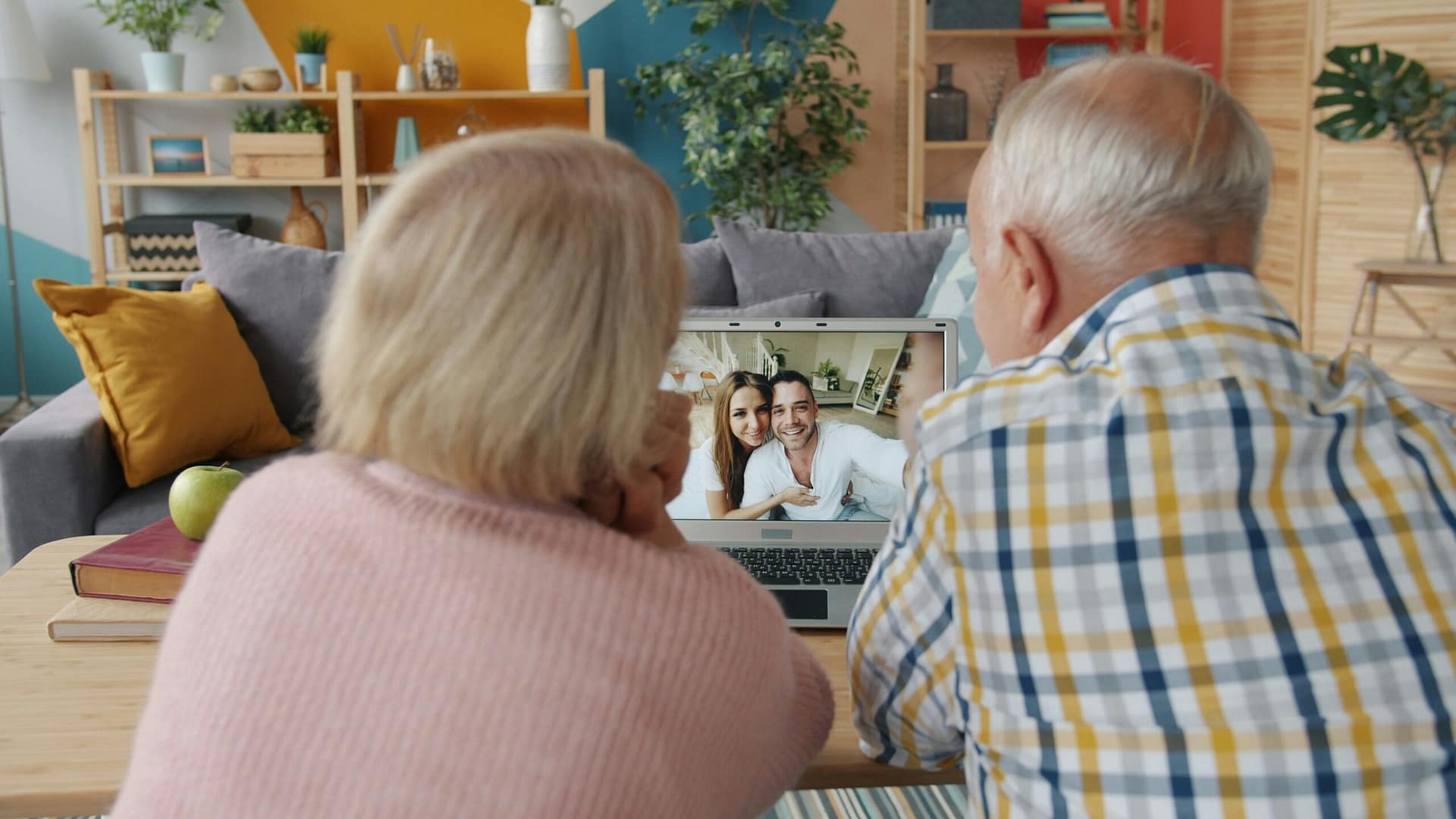 Senior couple video calling their adult son while talking through their plans of will and trust in Indiana