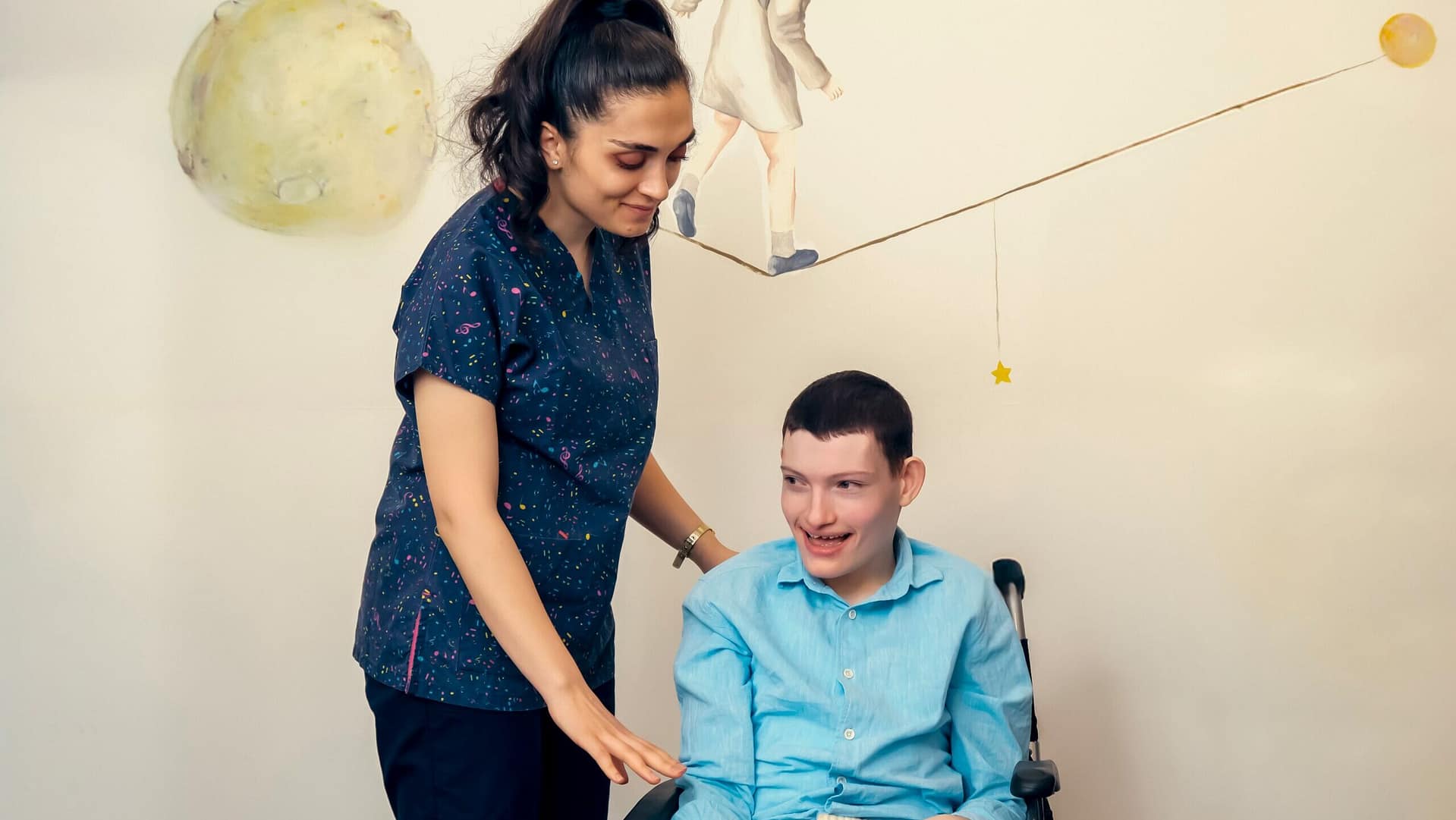Parent standing beside an adult child in a wheelchair, representing families considering guardianship for adults with special needs in Indiana.