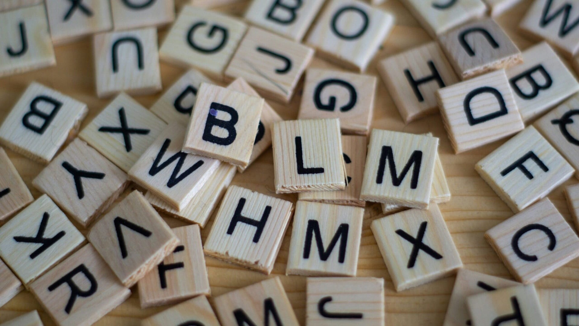 Scattered wooden alphabet tiles representing terms in CCSK Law's Indiana legal glossary